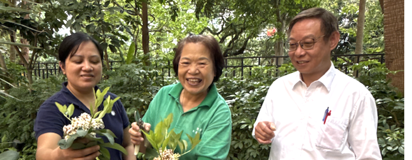 Penny showing Christina and Hok Man around her garden